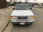 Front view of a 1995 Ford Ranger with 143,000 miles, in good condition, parked on a residential street.