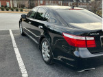 2008 Lexus LS 460 in black, showcasing sleek design and polished chrome wheels, parked on the street.