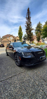 2016 Chrysler 300S black sedan with alloy wheels parked on driveway