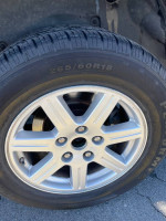 Close-up of a 2008 Chrysler Aspen wheel showing new tire in good condition for sale.