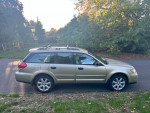 2008 Subaru Outback 2.5 XT Limited AWD in gold, featuring khaki leather trim, parked outdoors.
