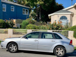 Silver 2024 Chevrolet Malibu parked in residential area, featuring moon roof and clean title, runs great.