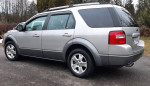 2007 Ford Freestyle in silver, parked with clean body and Michelin snow tires, ideal family vehicle.