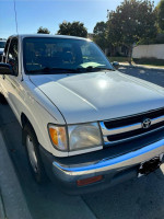 White Toyota Tacoma SR5 with minor rust, new tires, and clean interior ready for work or play.