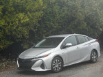 2021 Toyota Prius Prime plug-in hybrid parked, showcasing its sleek design and modern features.