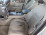 Interior view of a 2004 Lincoln LS showing seats and gear shift in good condition