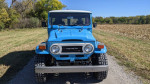 Front view of a 1977 Toyota Landcruiser BJ40 showcasing its blue paint and rugged design