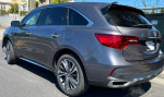 2020 Acura MDX in excellent condition with salvage title and 81000 miles, parked on the street.