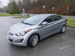 2015 Hyundai Elantra parked with winter tires, showing sleek design and good condition, suitable for winter driving.