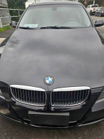 Front view of a black 2007 BMW 335i with twin turbo, showcasing the iconic grille and logo.