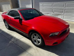 2012 Ford Mustang convertible in red parked in garage, excellent condition with new smog check.