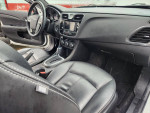 Interior view of a 2013 Chrysler 200 featuring black leather seats and modern dashboard design