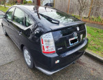 2009 Toyota Prius parked on the street, showcasing its sleek design and new battery pack.