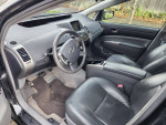 Interior view of a 2009 Toyota Prius with leather seats and dashboard features