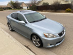 2010 Lexus IS 250 RWD in blue with clean title, back up camera, and sunroof, parked in residential area.
