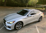 2015 Infiniti Q50 Sport in Liquid Platinum, showcasing sleek design and premium features in a parking area.
