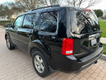 2011 Honda Pilot EX FWD in black color parked on a driveway, showcasing its well-maintained exterior.