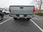 Rear view of a restored 2003 Dodge Ram 2500 Diesel parked, showcasing new paint and chrome bumper.