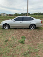 Side view of a 2002 Lexus ES 300 parked on grass, featuring tinted windows and alloy wheels.