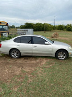 2002 Lexus ES 300 in silver parked on grass, showing wear and tear with tinted windows