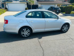 2024 Volkswagen Jetta silver car parked with a clean look, showcasing its design and features.
