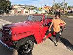 1950 Willys Jeepster Resto Rod in red color parked on the street, featuring custom upholstery and modern upgrades.