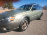 2005 Subaru Outback in green color with all-wheel drive and stylish rims, parked outdoors.