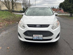 Front view of a 2014 Ford CMax Hybrid with clean title and low mileage, parked on a road