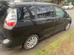 Side view of a 2007 Mazda 5 wagon, black color, parked with clean interior and good exterior condition.