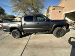 2018 Toyota Tacoma SR5 4WD with 2-inch lift, well maintained, unique TRD Pro grill, parked in driveway.