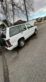 1993 Oldsmobile Bravada SUV for sale, white color, showing rear view with well-maintained exterior.