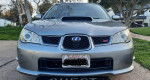 Front view of a 2007 Subaru Impreza WRX STI in silver color, showcasing its sporty design and features.