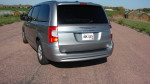2013 Chrysler Town & Country Touring minivan rear view on a rural road.