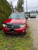 2008 Ford Escape AWD in red, showing front view, ideal as a budget-friendly first car with good snow performance.