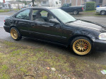 Black 1996 Honda Civic with gold rims parked on the street, featuring manual transmission and various new parts.
