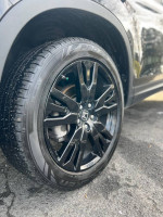 Close-up of a black wheel on a 2019 Honda Passport Sport, showcasing sleek design and quality tire.