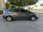 Side view of a 2011 Toyota Prius hybrid, gray color, parked outdoors with clean title and minor cosmetic damage.