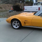 1973 Chevrolet Corvette Stingray in vibrant yellow, showcasing its sleek design and custom wheels.