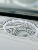 Close-up of Bang & Olufsen speaker in a 2012 Audi A5 interior, showcasing premium sound system features.