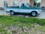 1972 GMC C10 short bed pickup truck in green and white, parked on grass with clean title for sale.