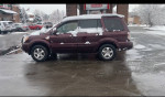2008 Honda Pilot SUV parked in snow, featuring low mileage and a clean title, ready for winter driving.