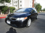 2008 Honda Civic LX FWD in black, well-kept with 98,000 miles, parked outside a building.