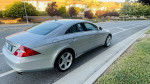 2007 Mercedes-Benz CLS550 with 84K miles, silver color, showing sleek design and parked on a street.