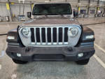 Front view of a 2019 Jeep Wrangler Sport 4WD in excellent condition with low mileage.